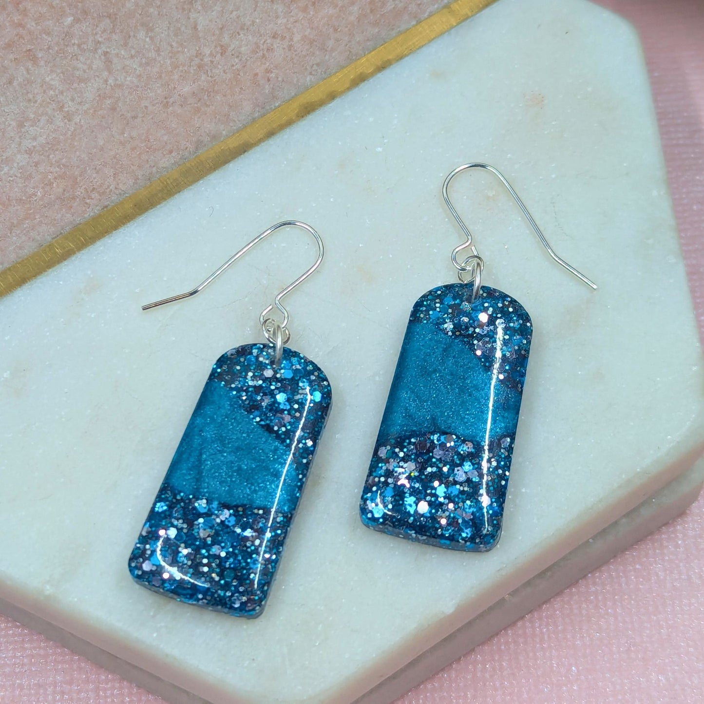 "Sarai" Blue Metallic Glitter Resin Arch Earrings