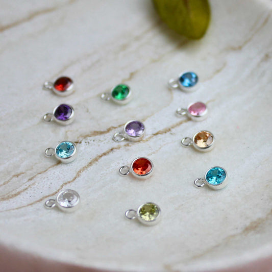 Add a touch of personalised sparkle to your jewellery collection with our 4mm Cubic Zirconia Birthstone Charm! Available in Sterling Silver.