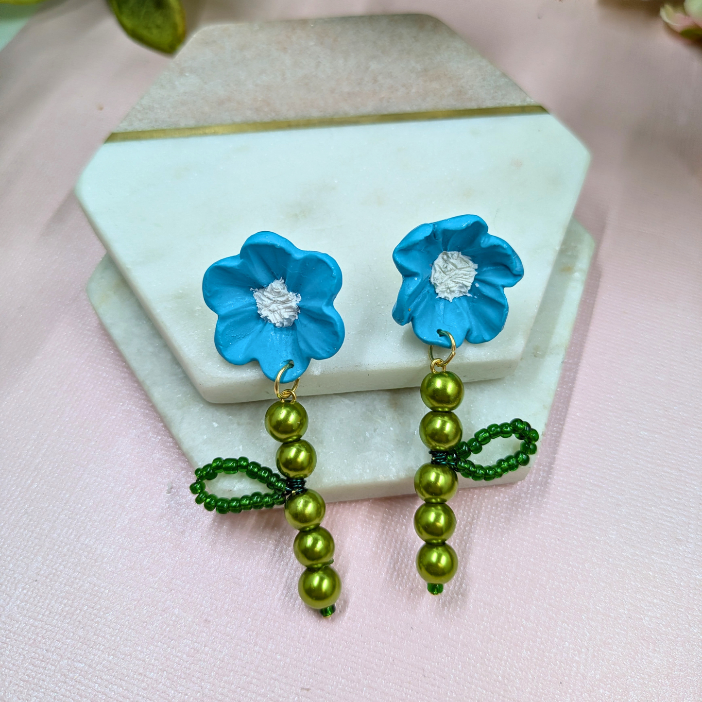 Detailed view of green glass bead and pearl stem on Fern earrings