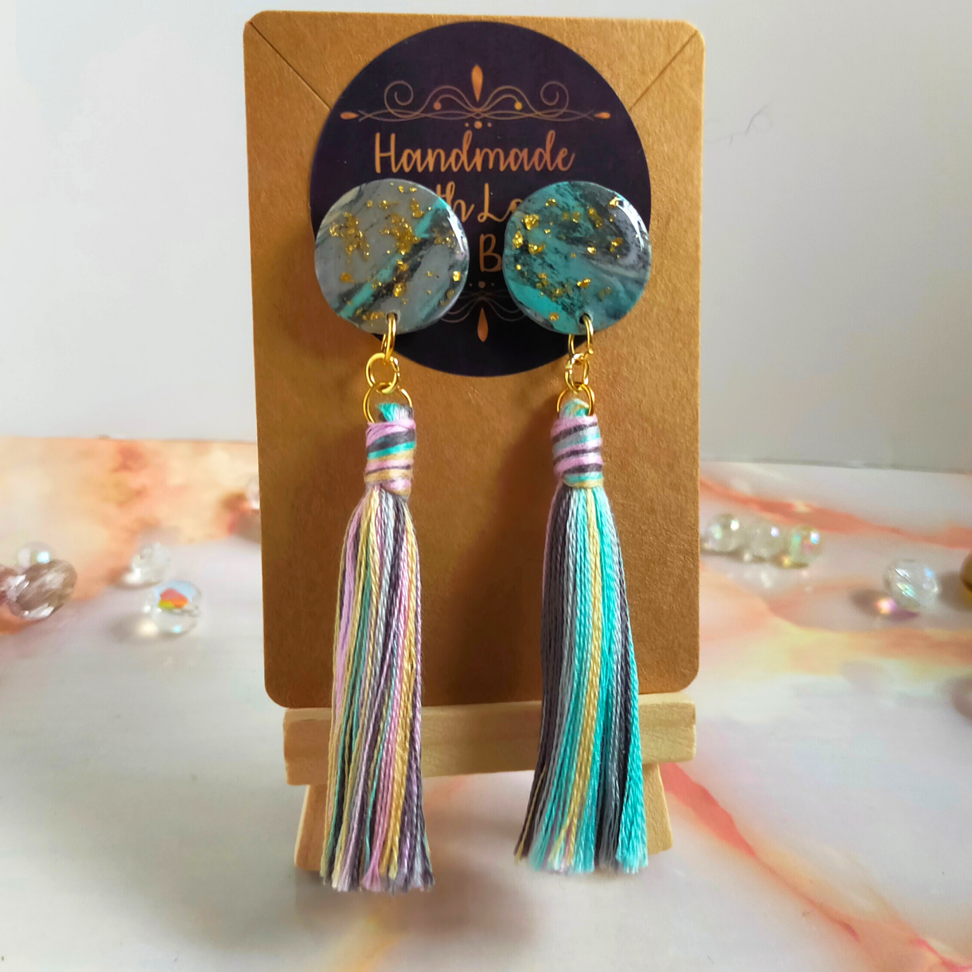 Handmade in our West Yorkshire Studio, these unique, one-of-a-kind faux marbled polymer clay earrings with tassel charm are the perfect gift for any stylish women.