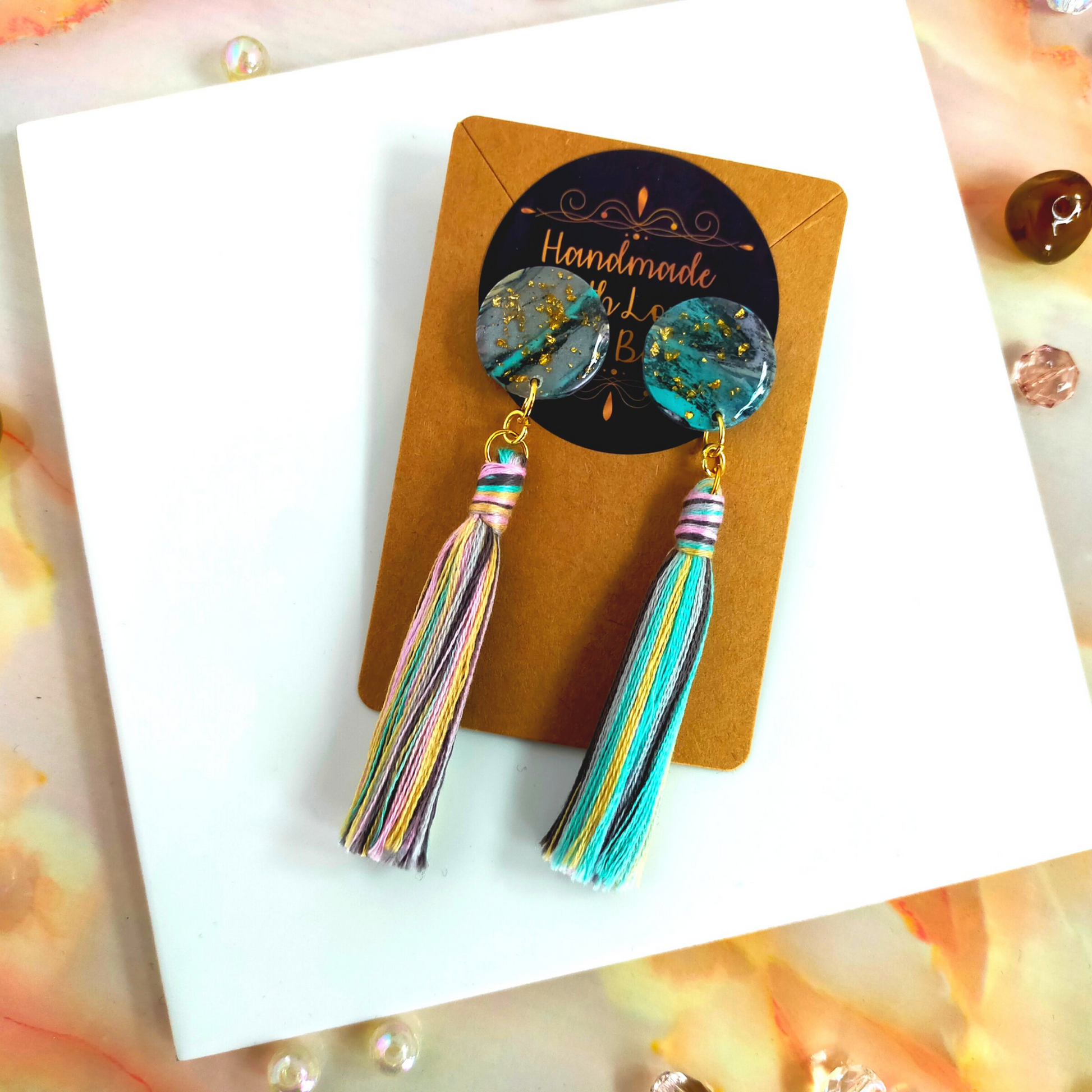 Handmade in our West Yorkshire Studio, these unique, one-of-a-kind faux marbled polymer clay earrings with tassel charm are the perfect gift for any stylish women.