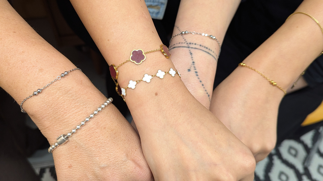 Three wrists wearing permanent welded gold and silver bracelets from Welded Bonds by Created By Lau, Shipley