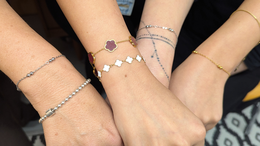 Three wrists wearing permanent welded gold and silver bracelets from Welded Bonds by Created By Lau, Shipley