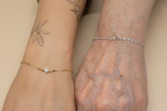 Two wrists wearing delicate permanent welded gold and silver bracelets — Welded Bonds by Created By Lau, Shipley