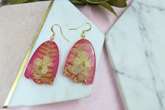 Handmade pink resin earrings with pressed flowers and gold detail by Created By Lau — slow fashion accessories made in Shipley, West Yorkshire