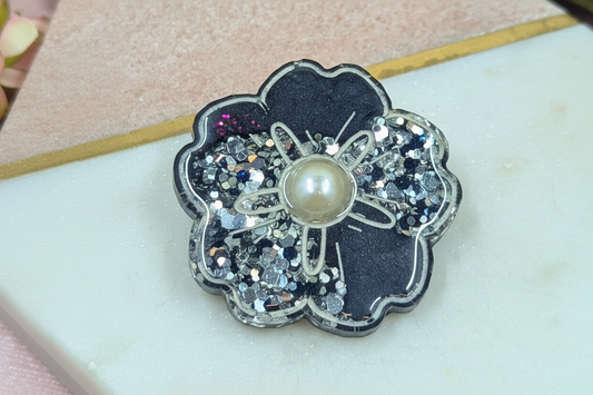 Handmade dark resin flower piece with pearl centre and glitter detail by Created By Lau — a timeless slow style accessory