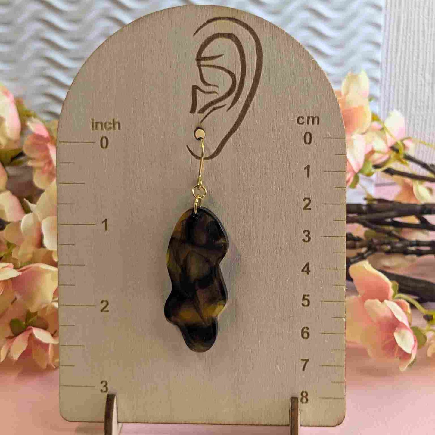 Billie Tortoiseshell Wavy Resin Dangle Earring on wooden measuring guide showing 7cm drop.