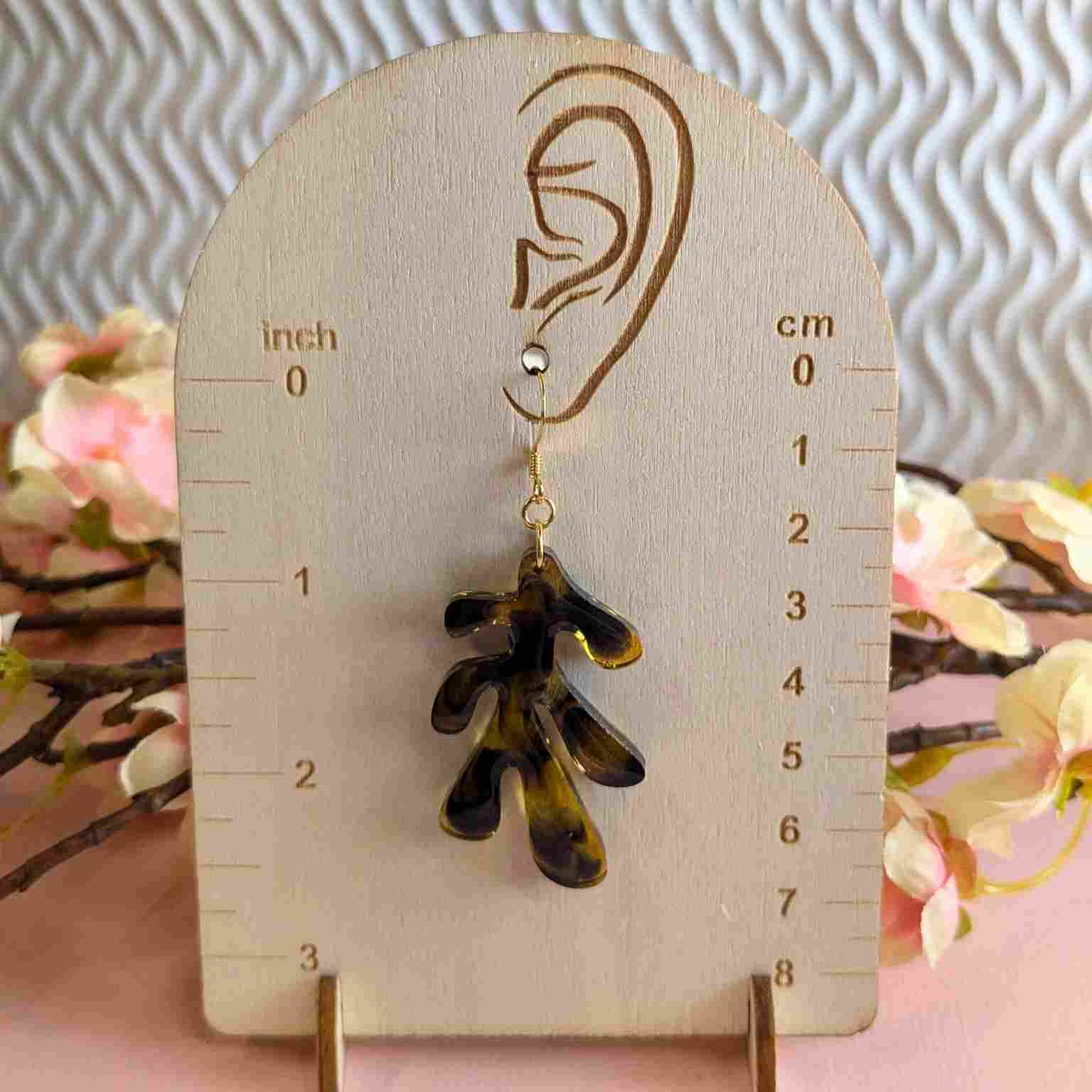 Pair of Dakota Tortoiseshell Resin Organic Leaf Earrings - Gold Plated Hooks on Woodern Meauring Board show 7 cm Drop