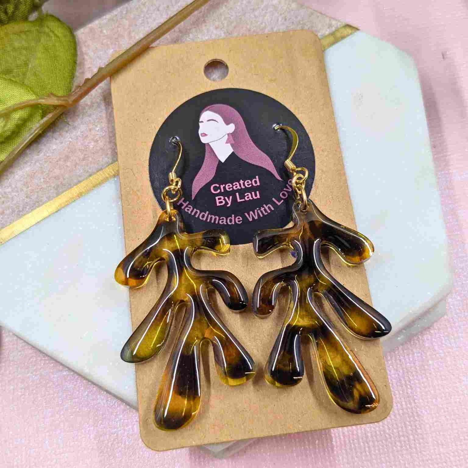 Pair of Dakota Tortoiseshell Resin Organic Leaf Earrings - Gold Plated Hooks on branded packaging