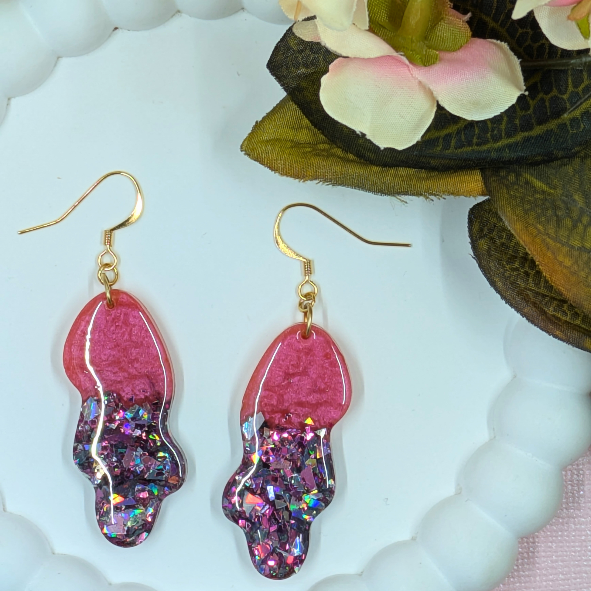 Wavy resin dangle earrings showing fluid oval shape and gold plated ear hooks by Created By Lau