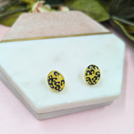 Hattie black animal print glitter resin stud earrings with yellow background handmade in Yorkshire
