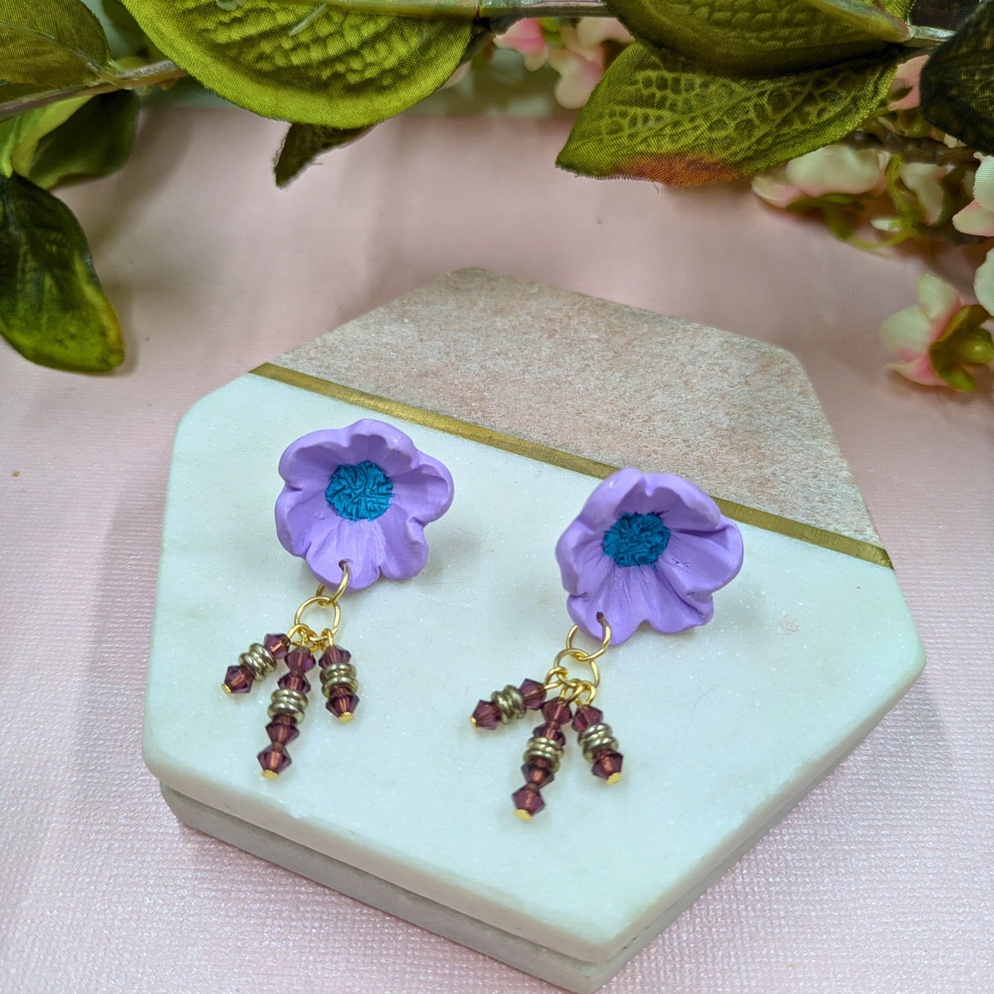 Close-up of three dangle chains on Beatrix bold statement earrings