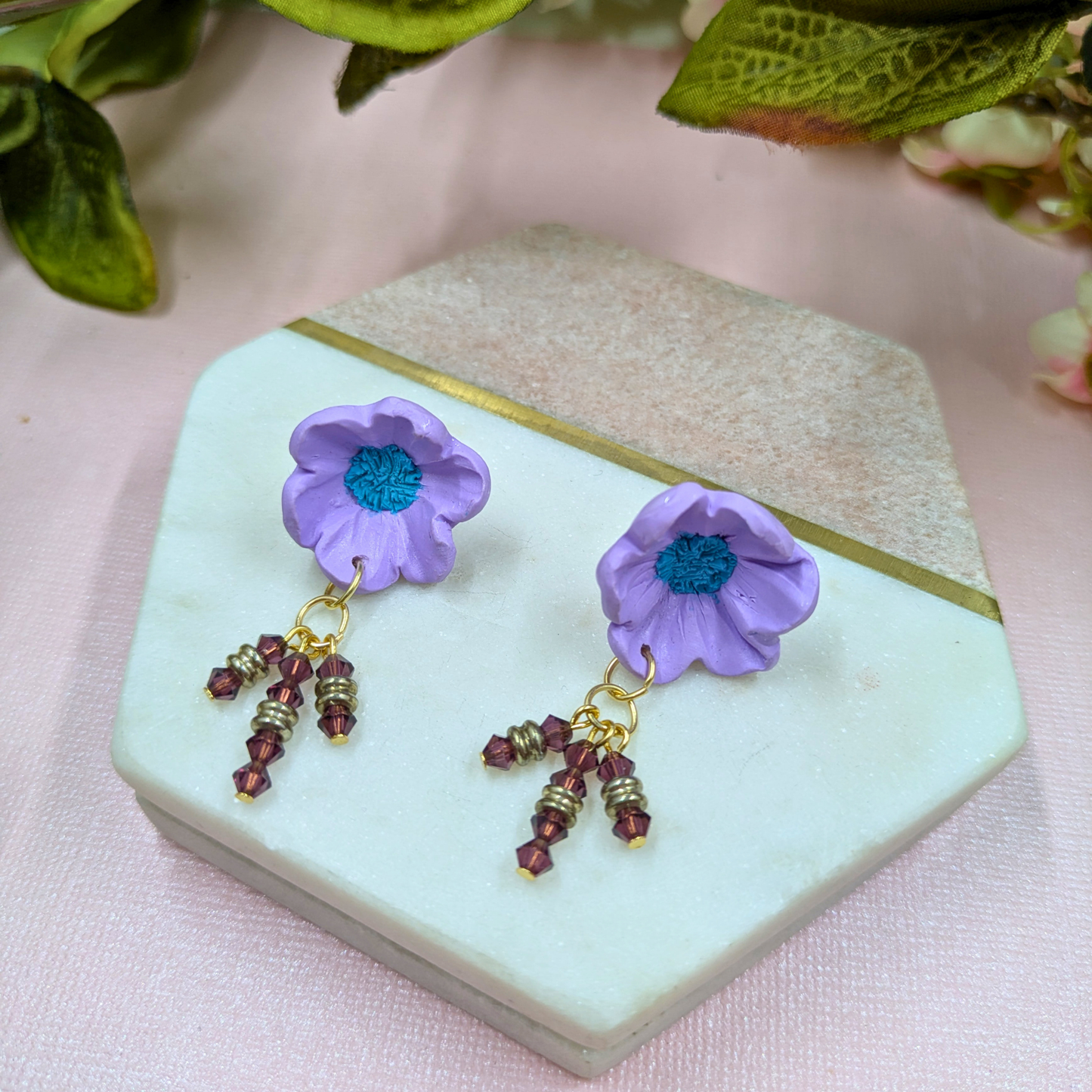 Front view of Beatrix handmade purple polymer clay flower stud earrings