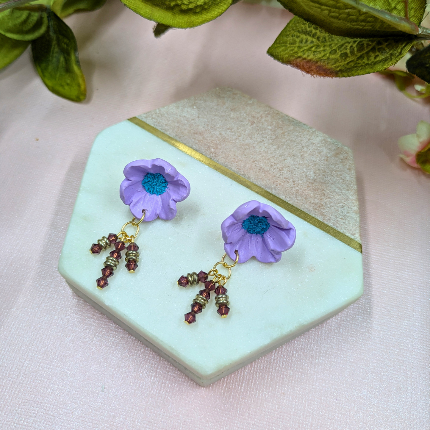 Gold metal bead accents on Beatrix purple statement earrings gold plated