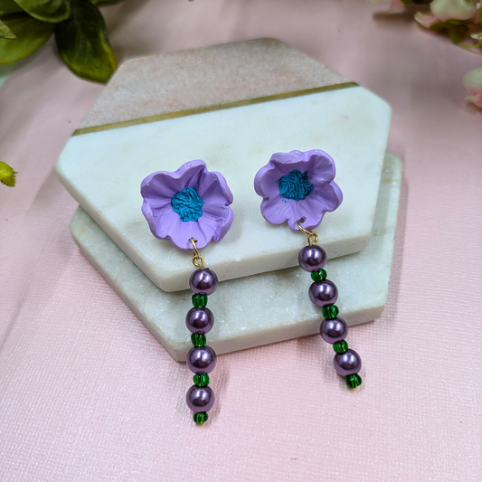 Front view of Sylvie handmade purple polymer clay flower stud earrings